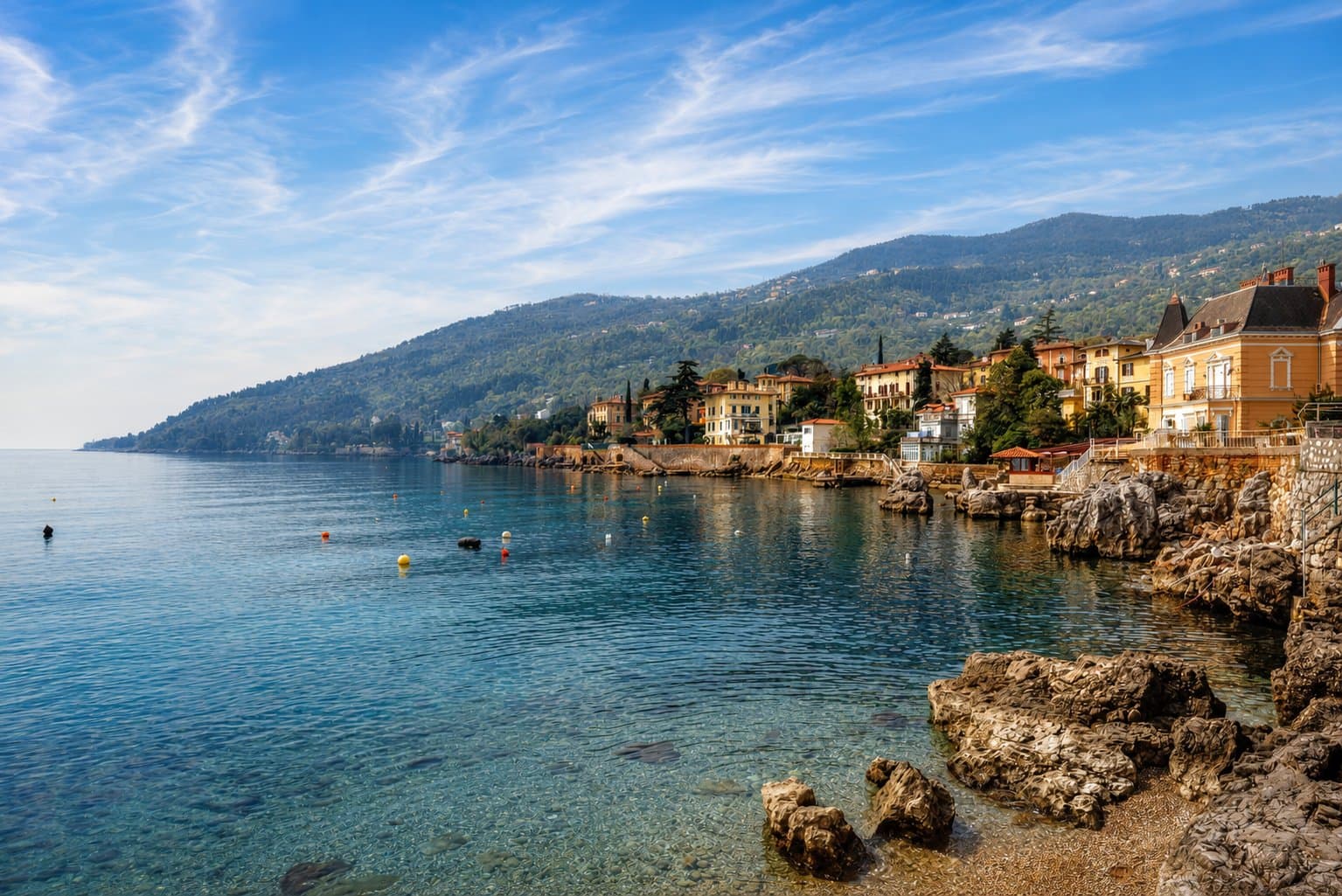 Lovran's rocky coast and waterfront villas in clear morning light