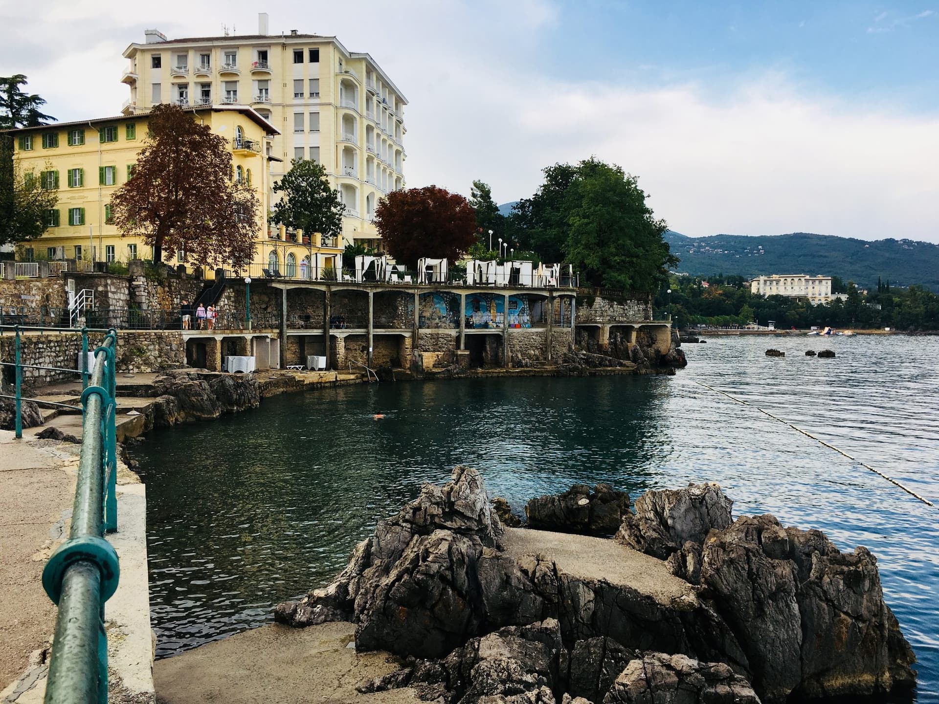 The Lungomare promenade curving below a grand Secession-era villa